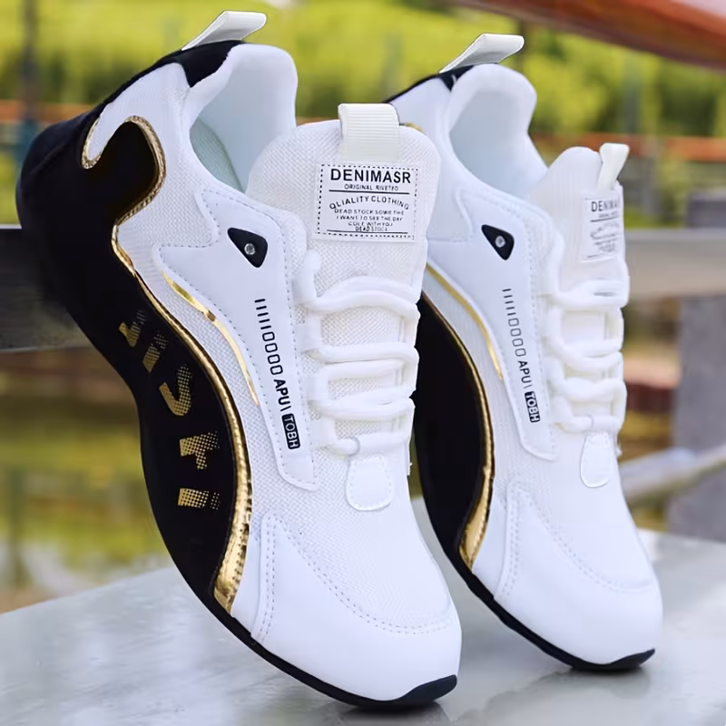 White and gold men's sneaker detail — gold accents and lace-up design